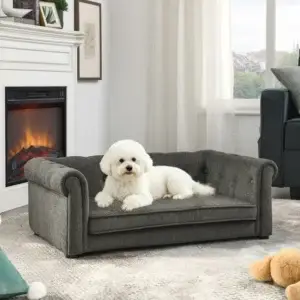 White fluffy dog lying on gray pet sofa